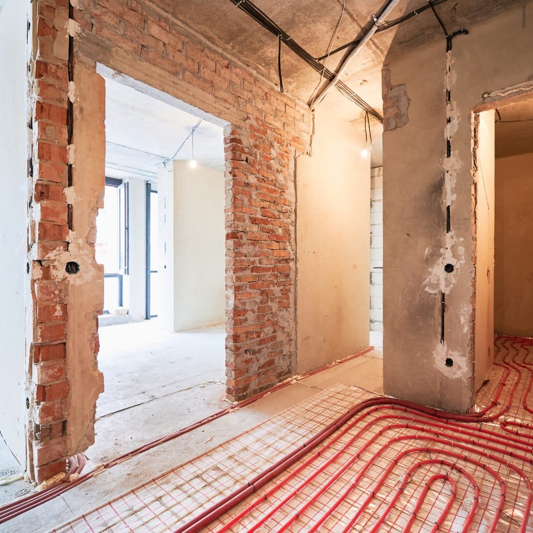Water underfloor heating pipes on the insulation panel during a refurbishment, before the screed