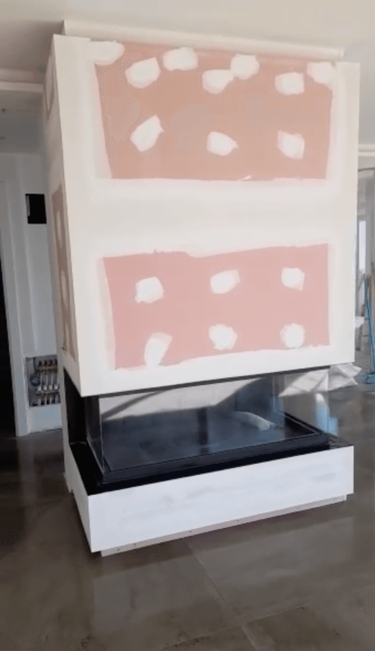 Wood-burning project: three-sided wood-burning fireplace with a lift-up door